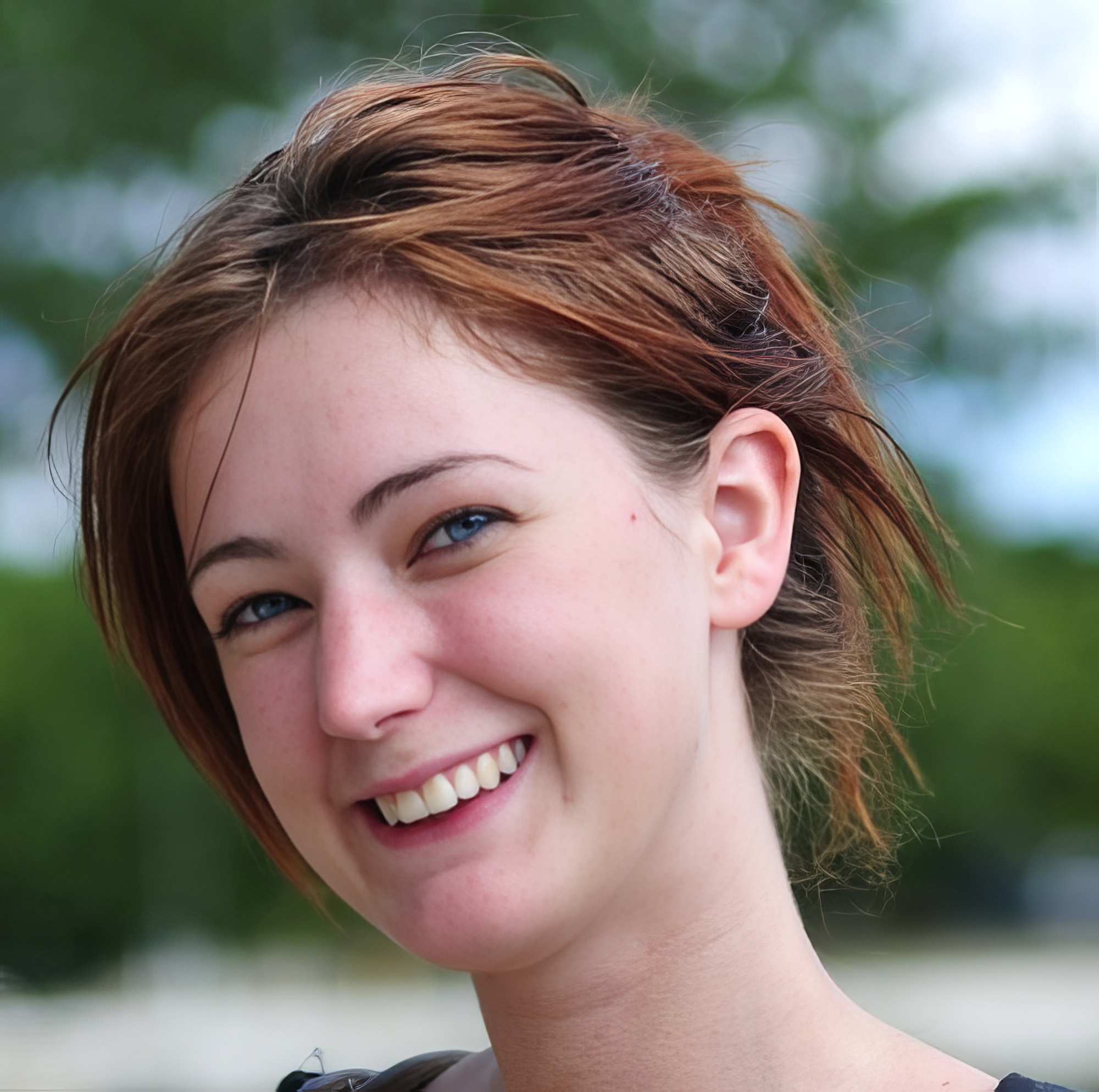 a woman with a toothy smile