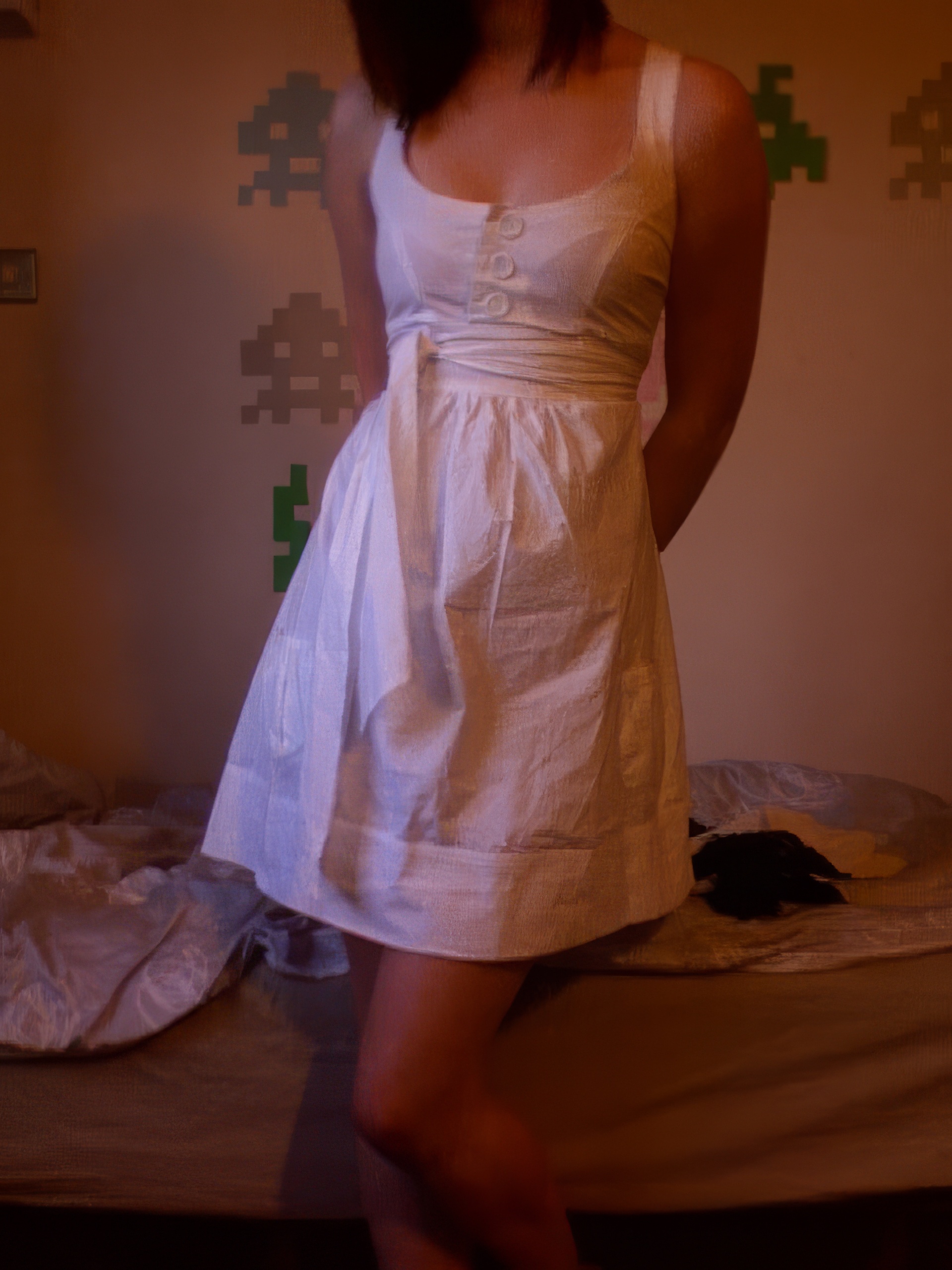 a woman in a white dress standing on a bed