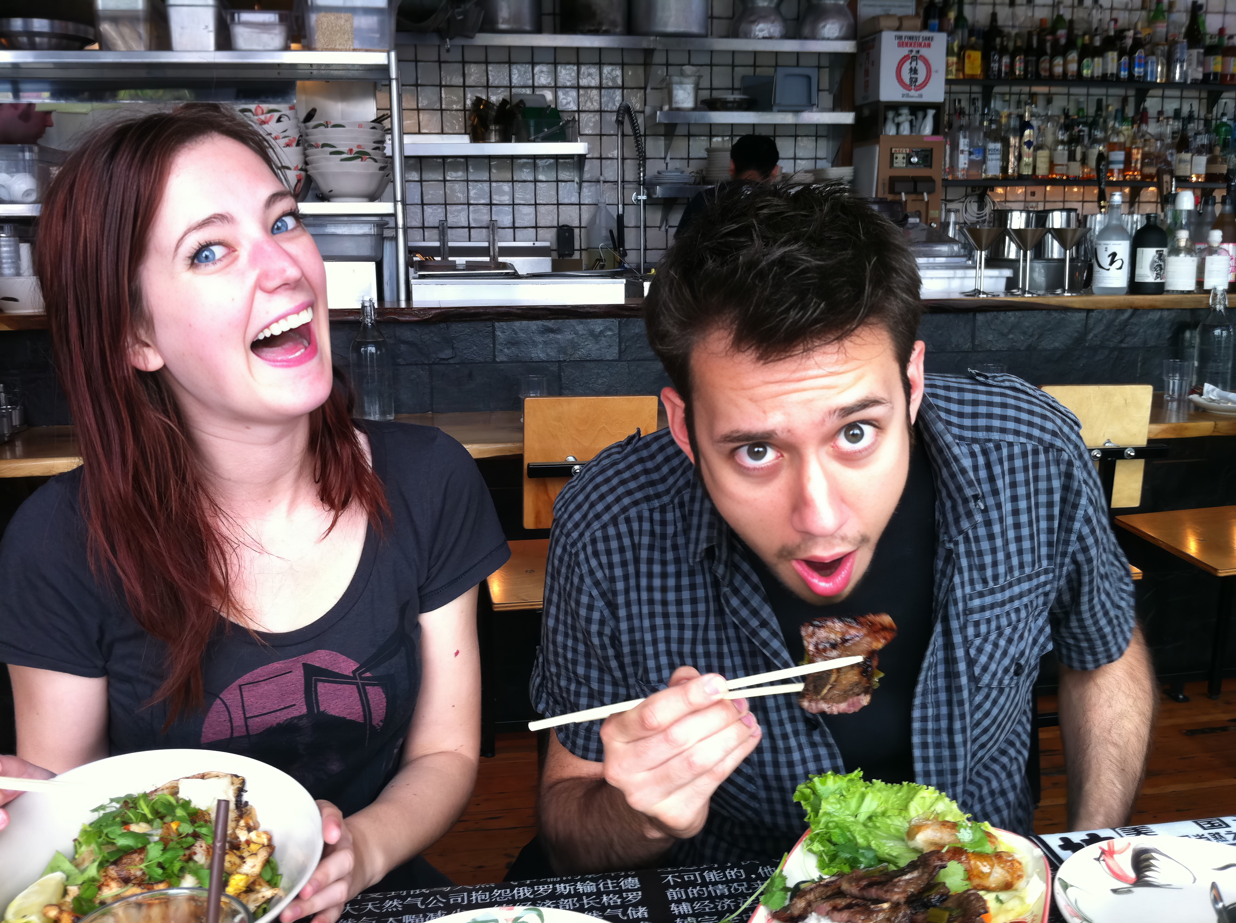 a man and woman eating food at a restaurant