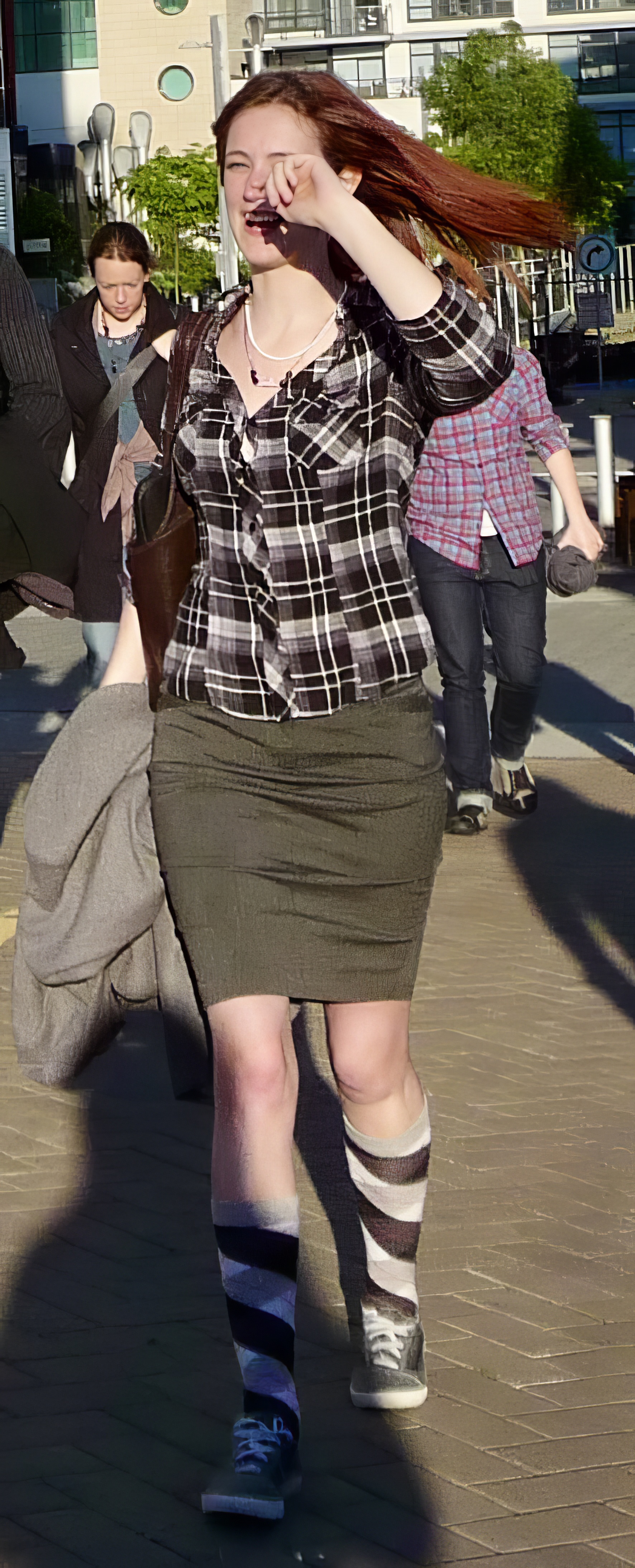 a woman walking on a sidewalk