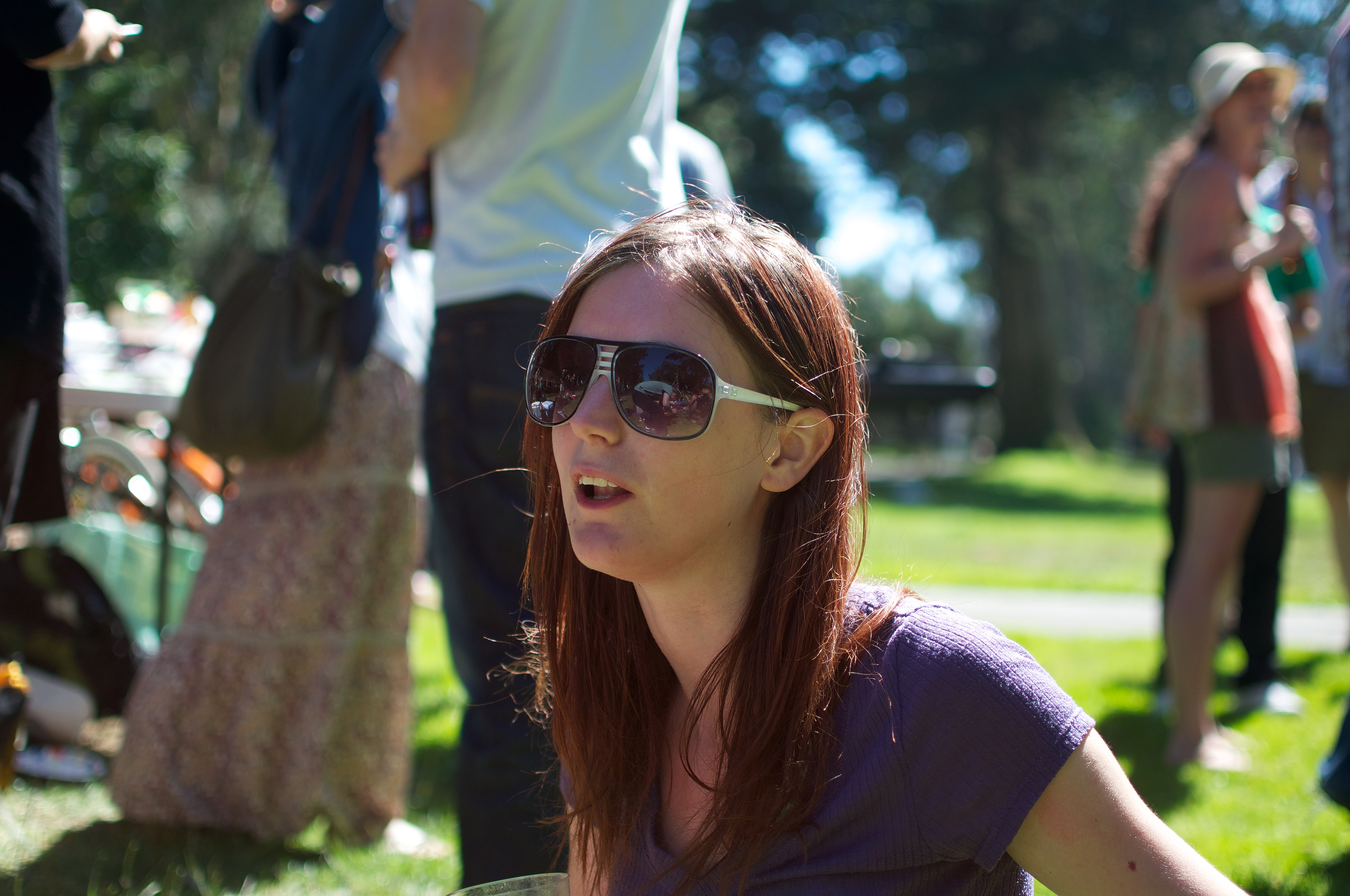 a woman sitting on the grass