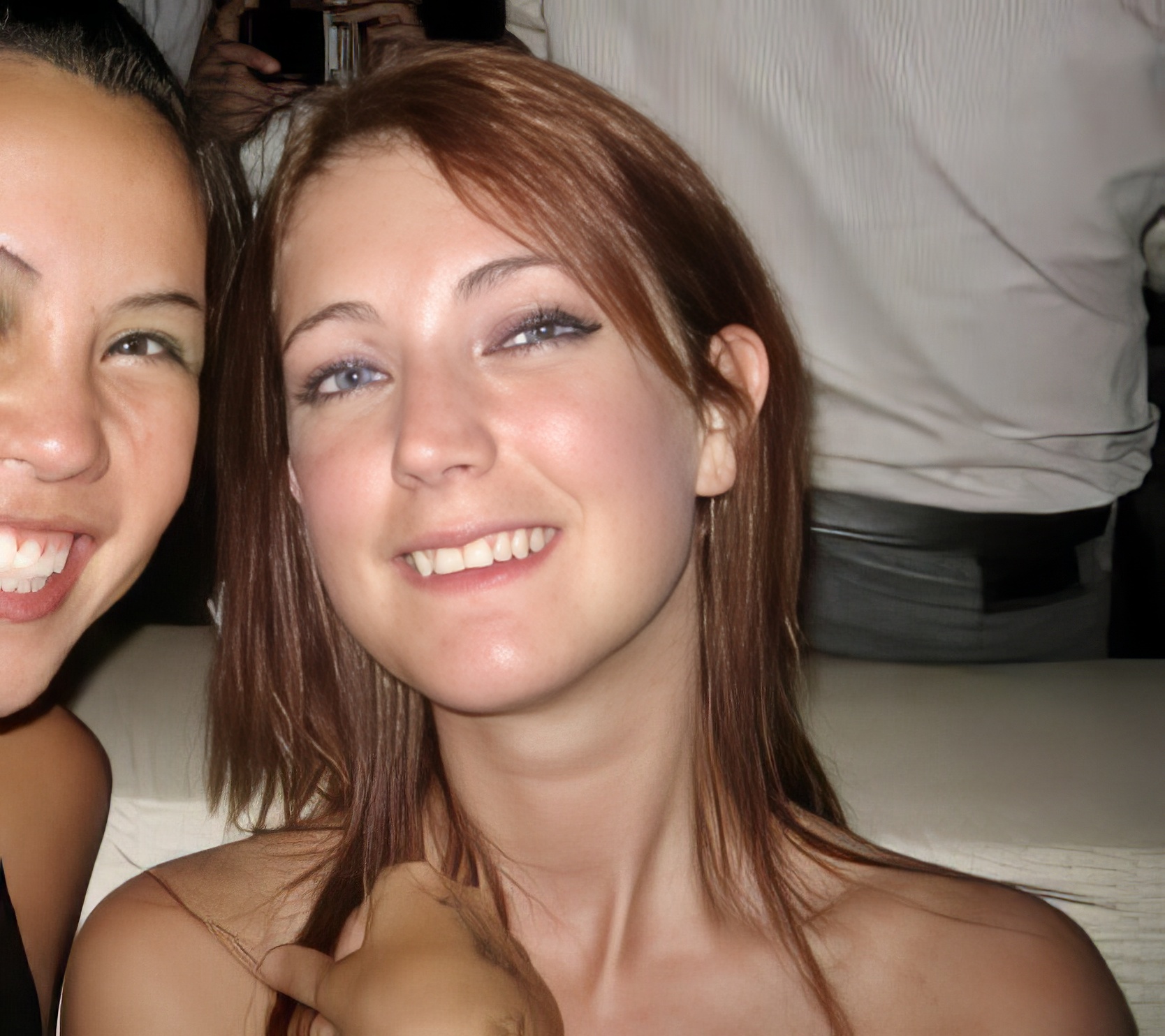 two women are smiling and posing for the camera