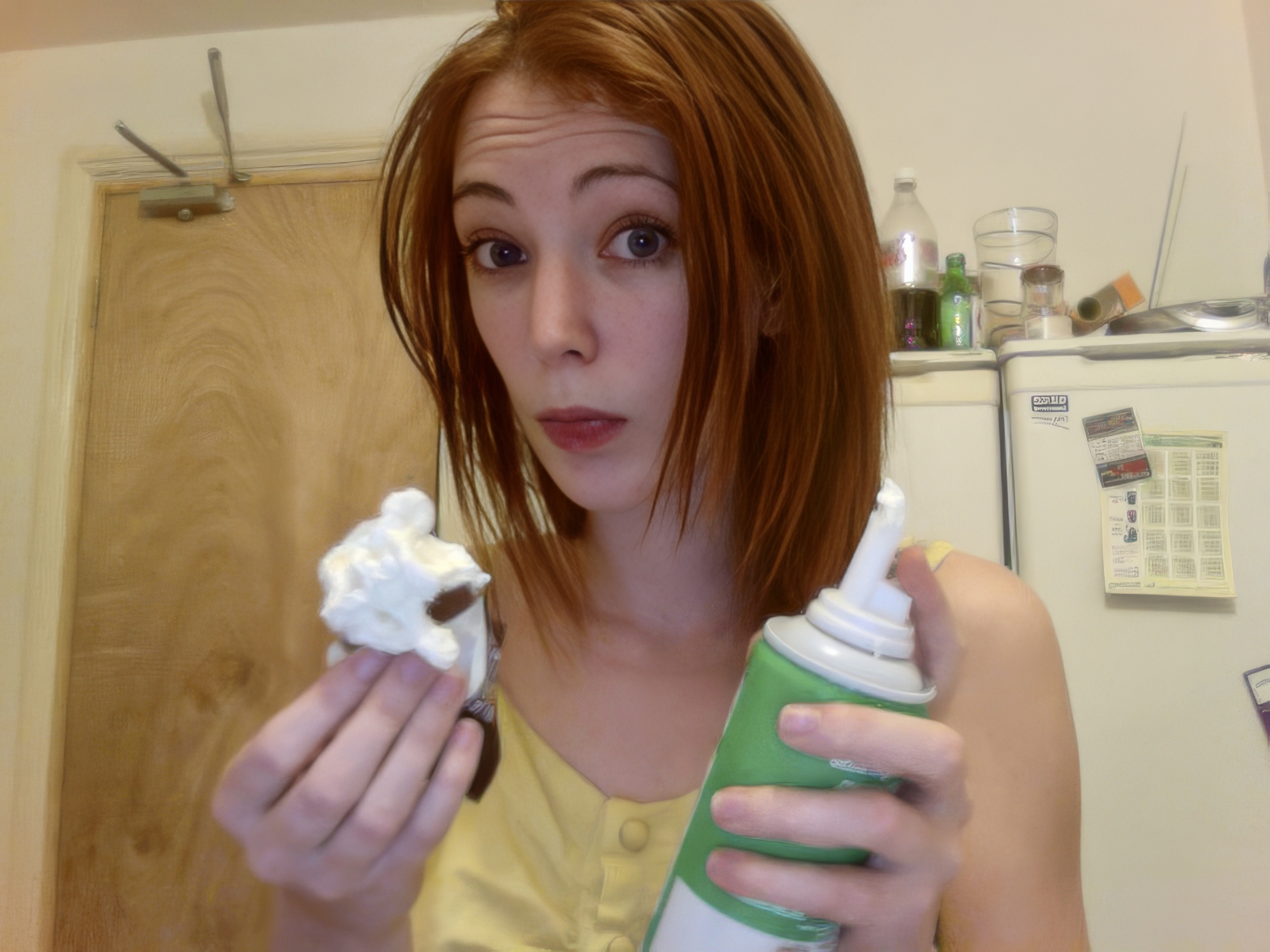 a woman holding a cup and a toothbrush