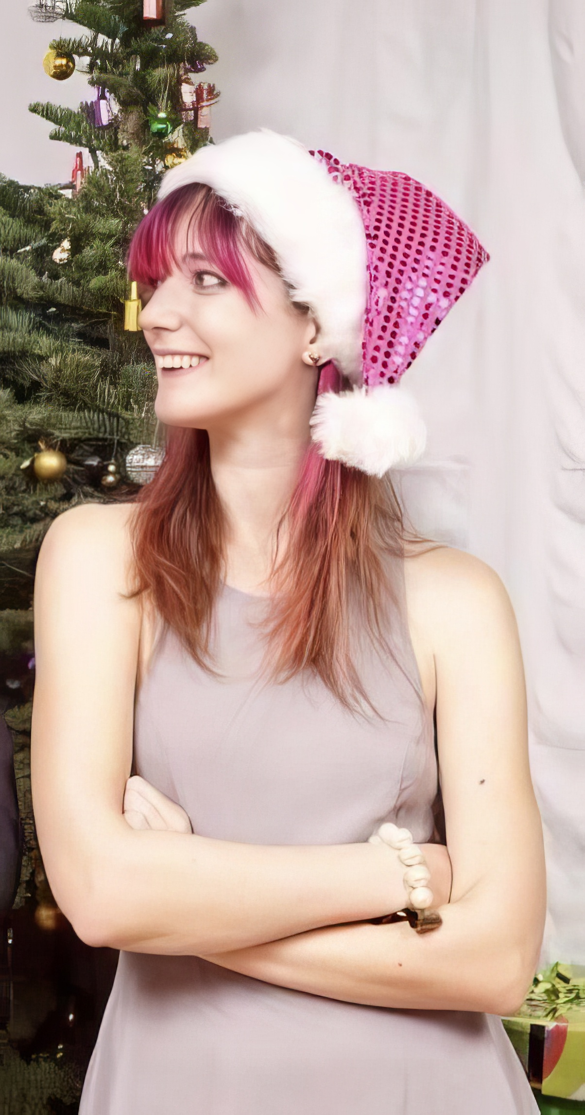 a woman wearing a pink hat and posing for a picture