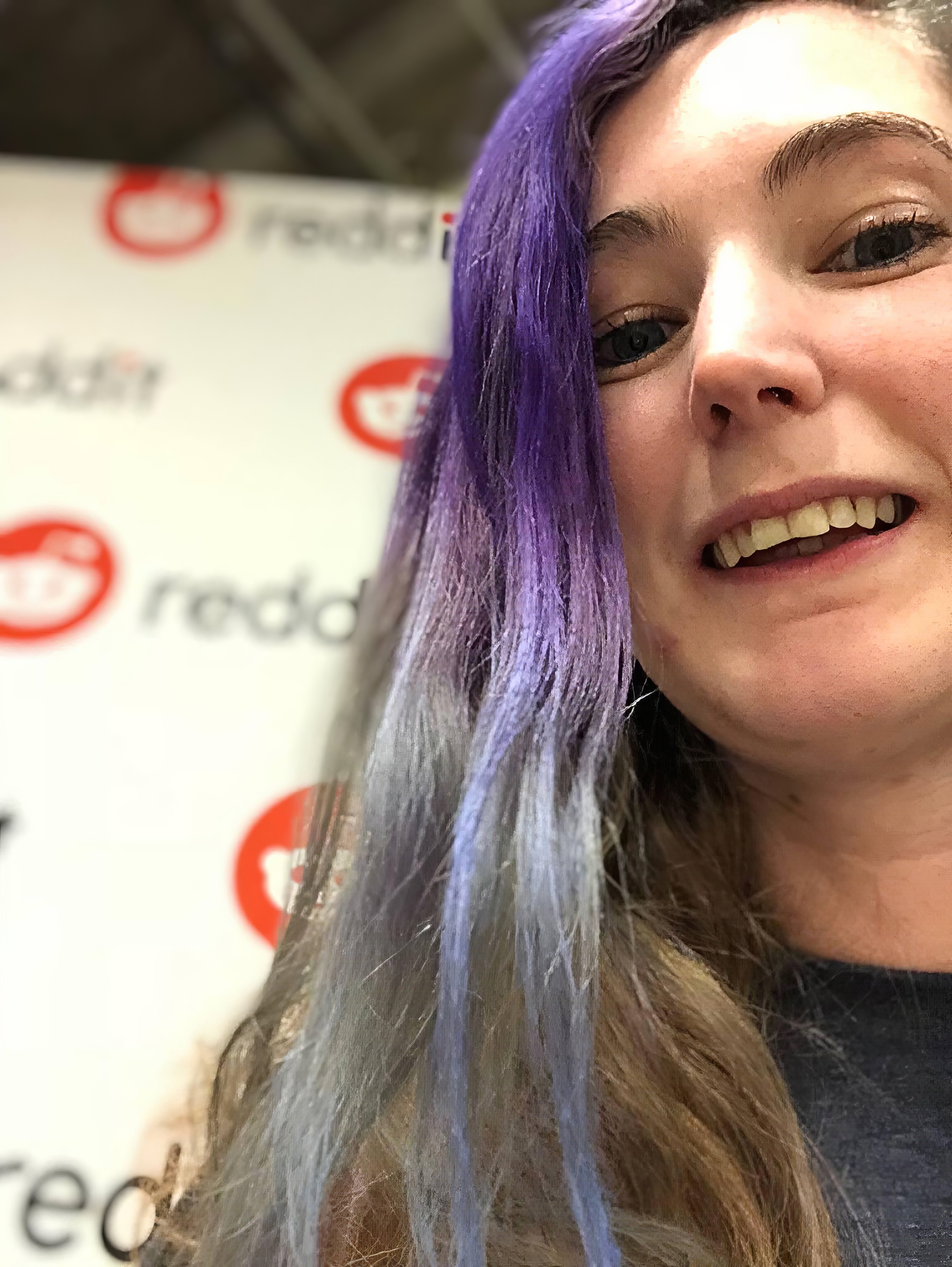 a woman with purple hair and a black shirt