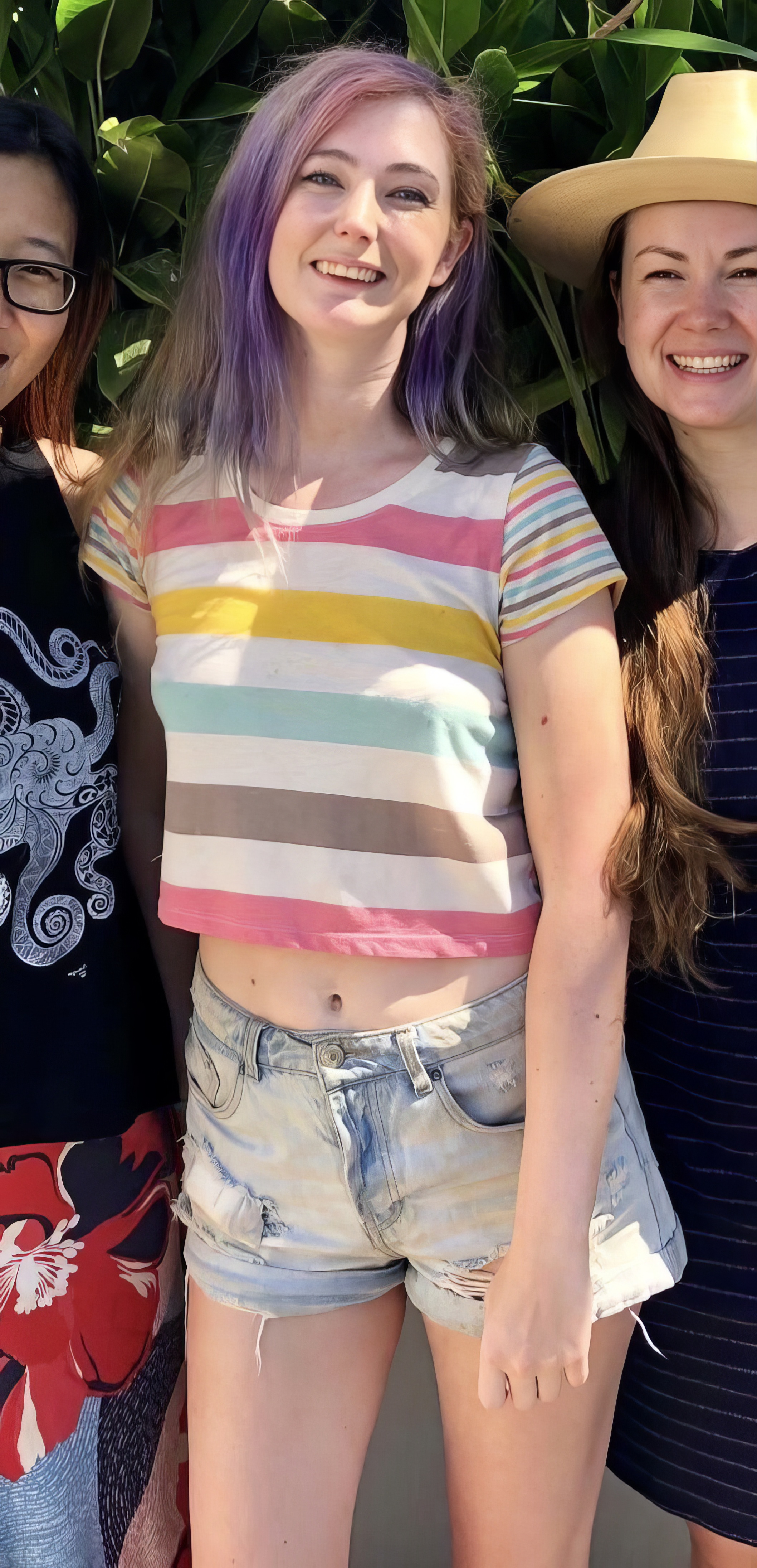 three girls in striped shirts and shorts posing for a photo