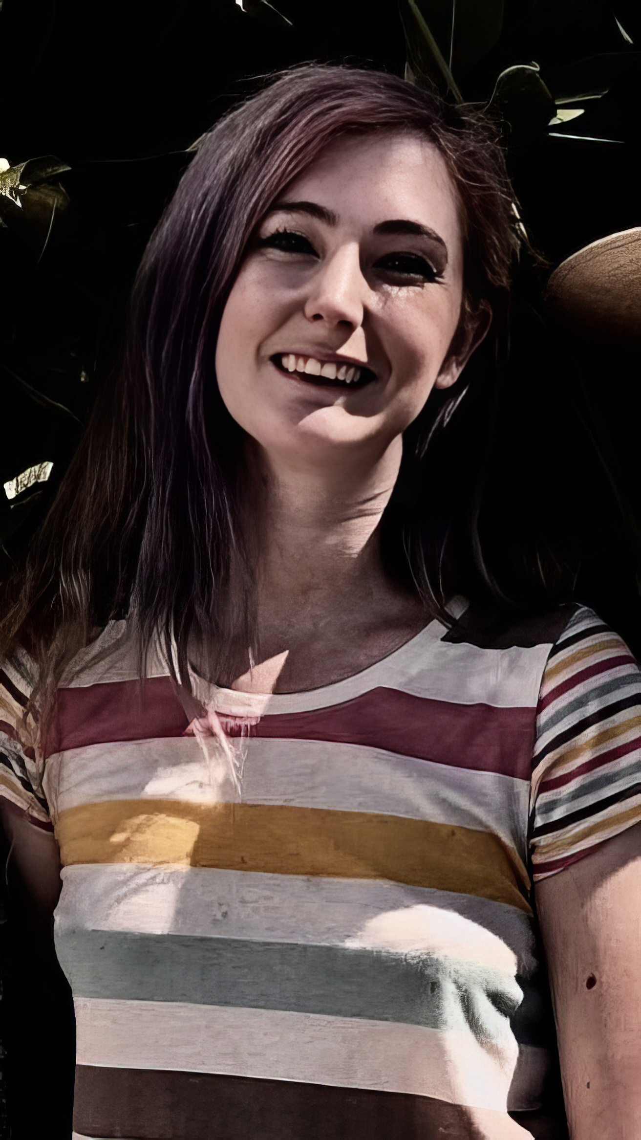 a woman with a hat and a striped shirt