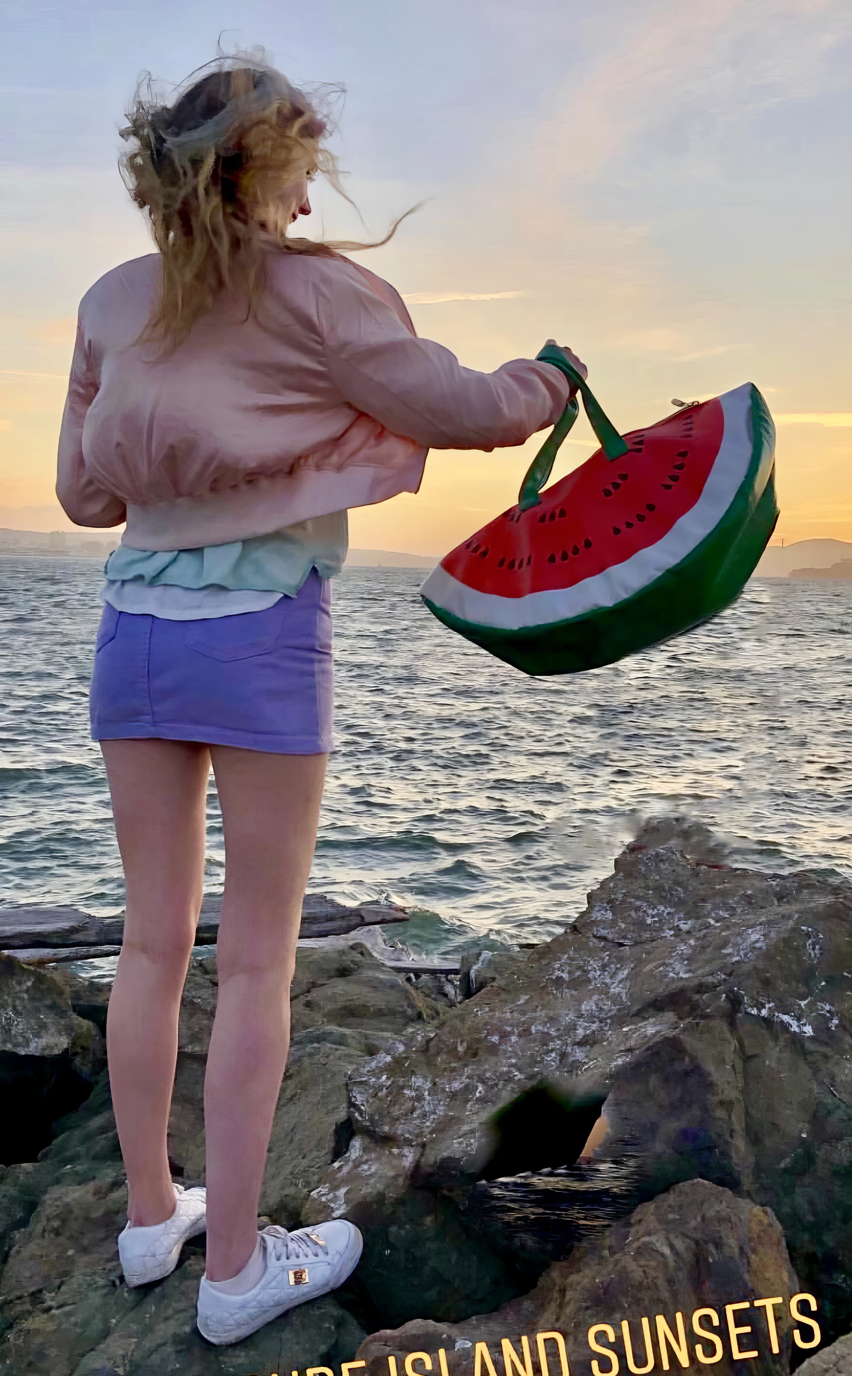 a woman standing on a rock with a watermelon