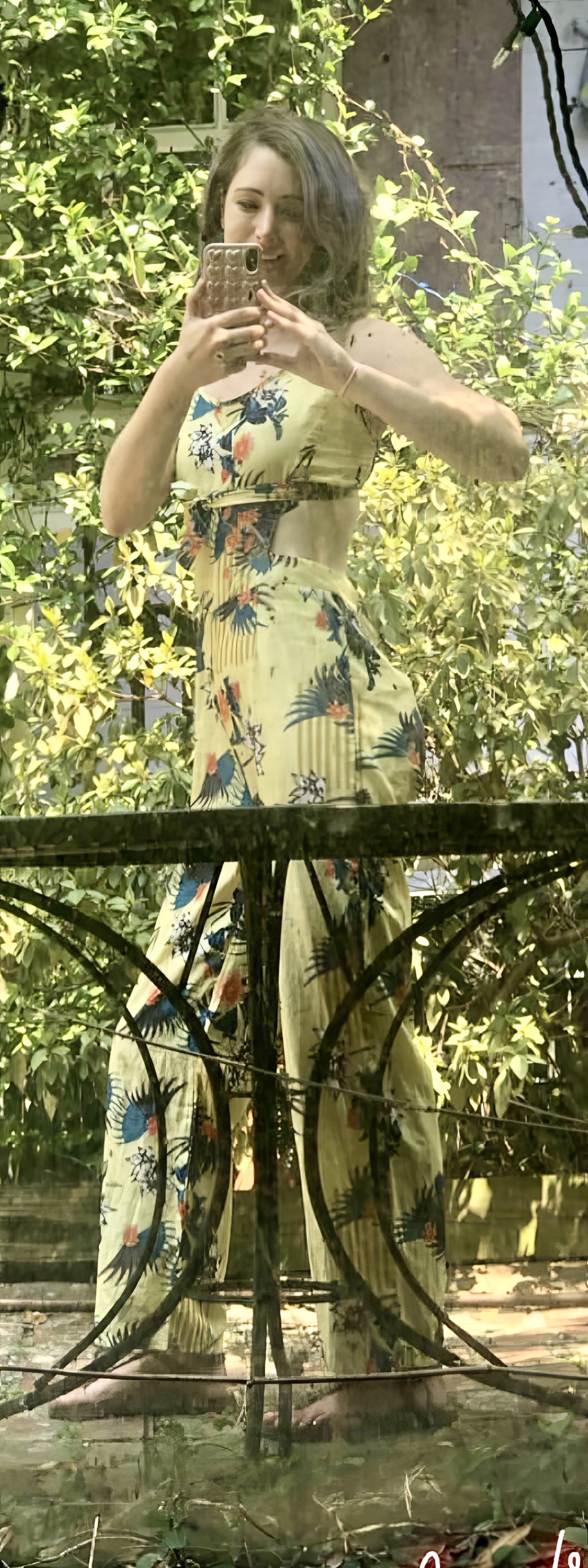 a woman in a yellow dress standing in front of a table