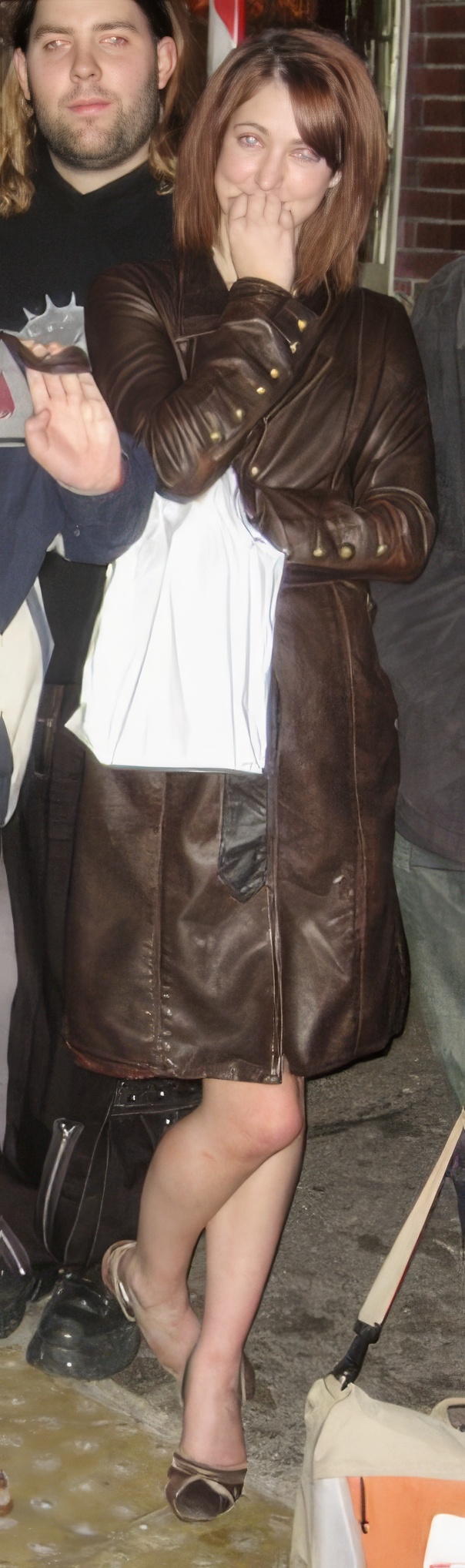 a woman wearing a brown jacket