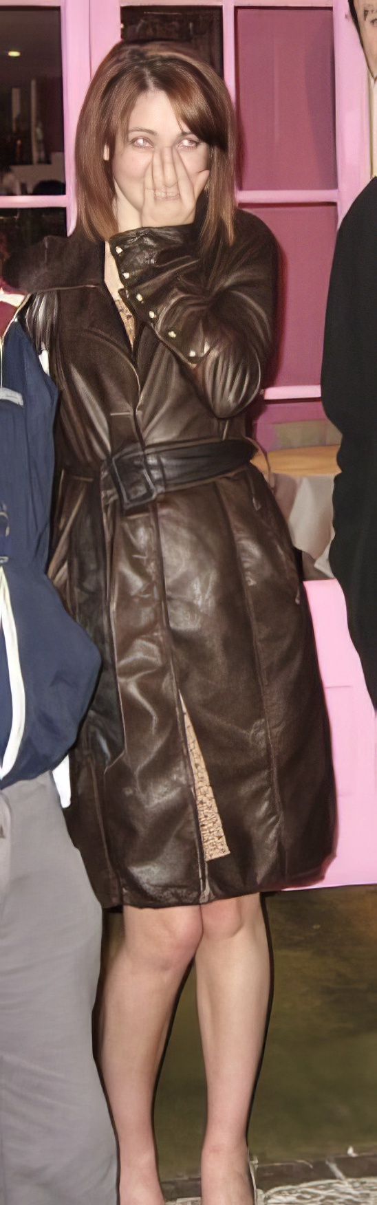 a woman wearing a brown leather coat