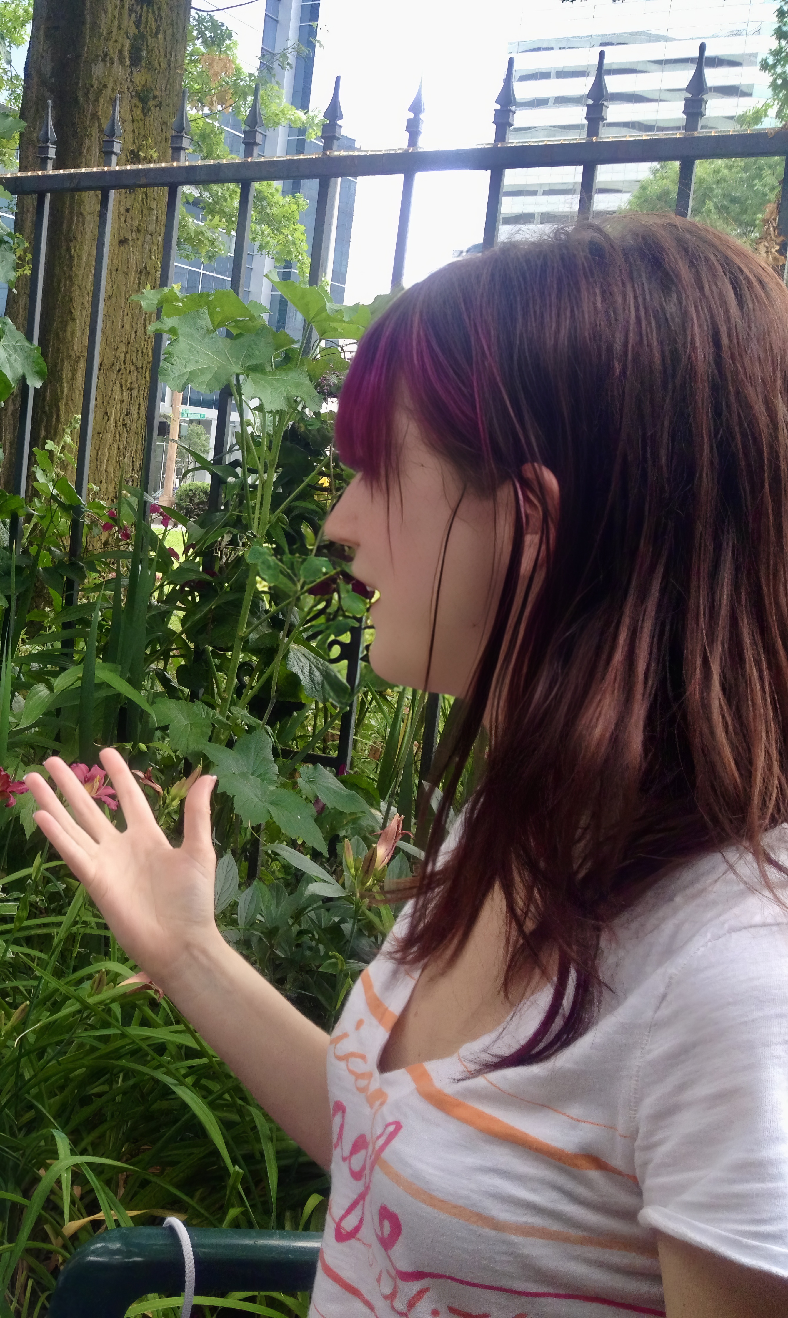 a woman is looking at a bird in a cage