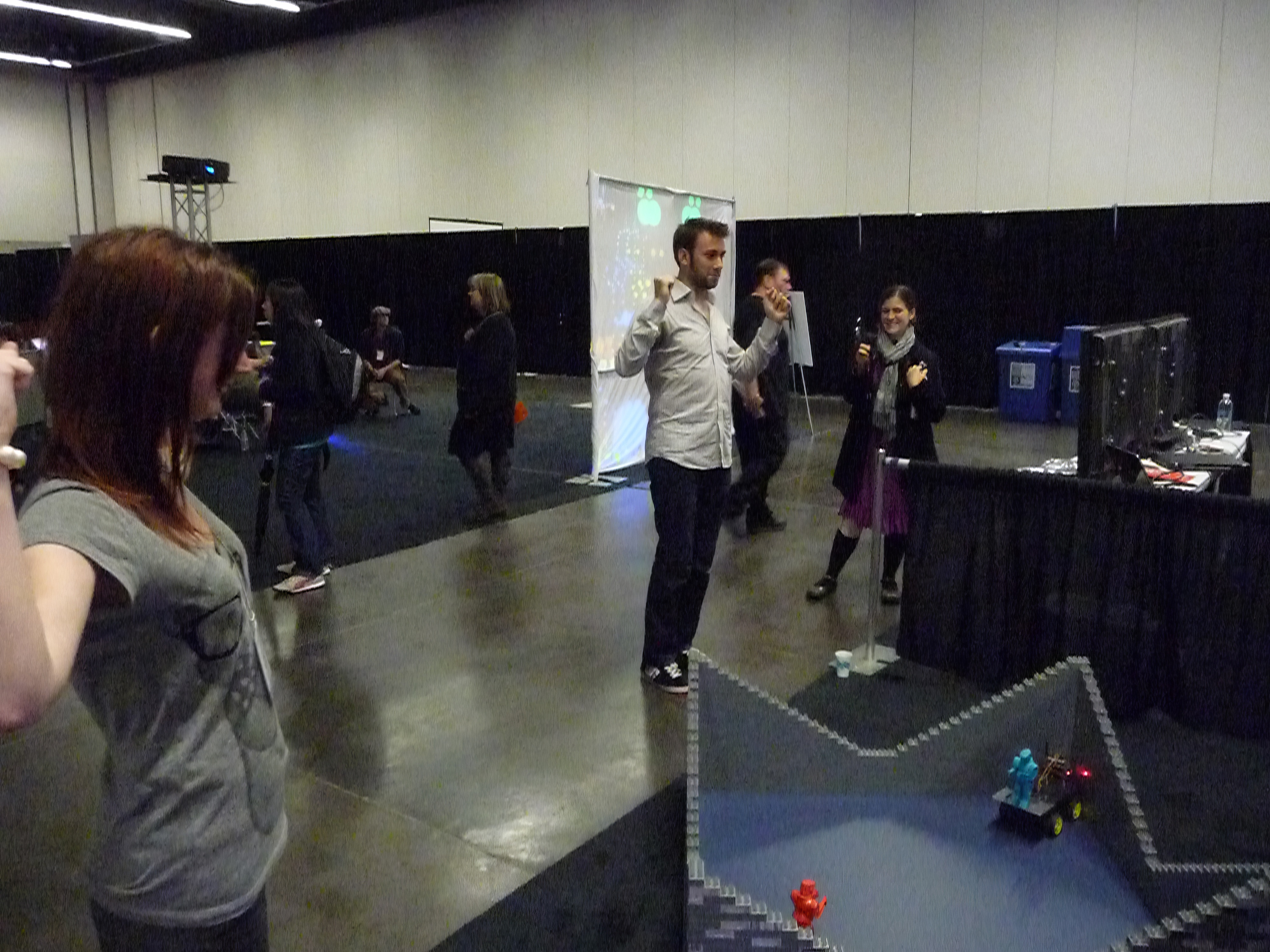 a group of people standing around a table %
Ae,
4
Ve
wtih.
Nill.

“Np
4h
Waseires arti nes iy