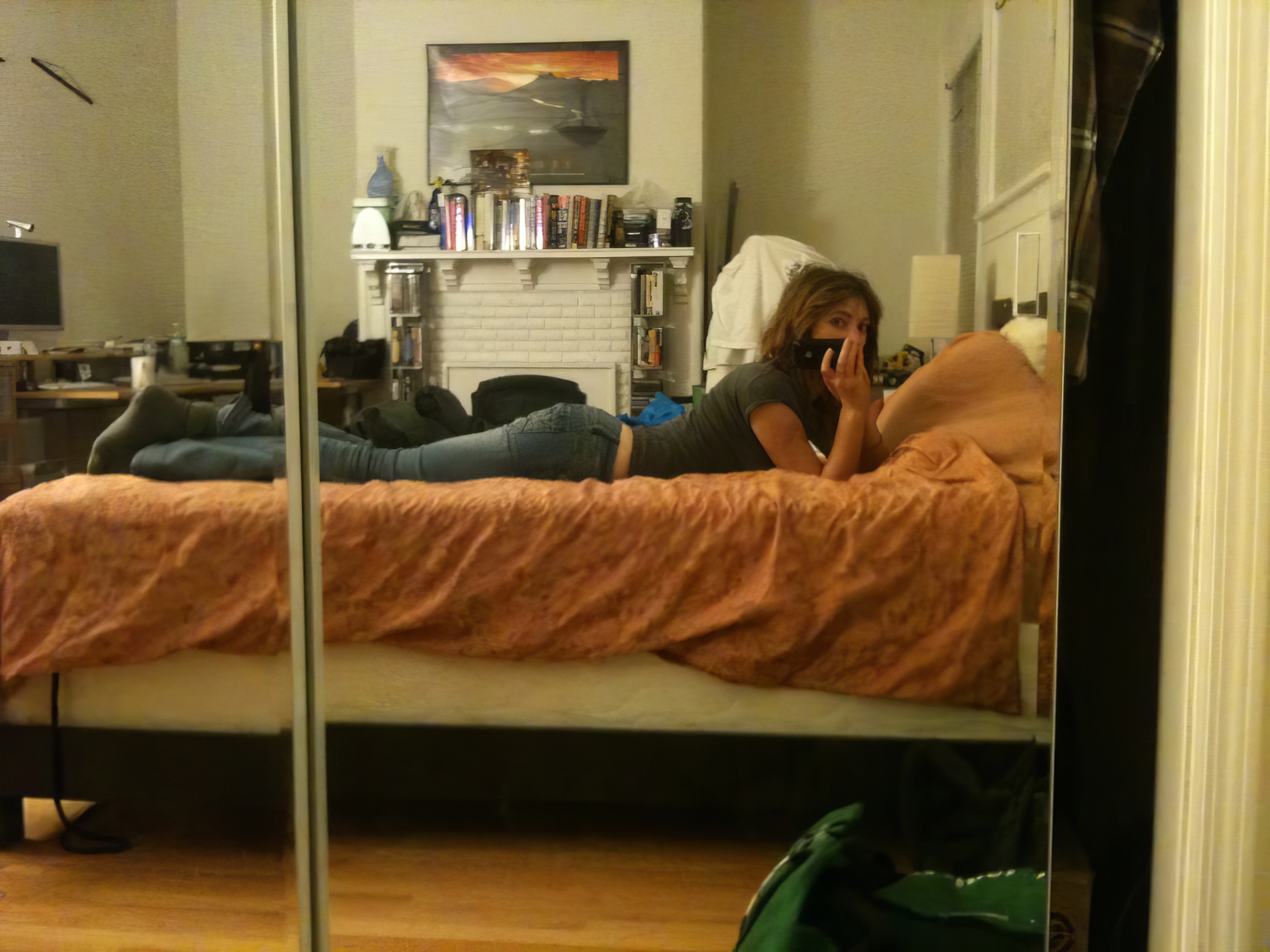 a woman laying on a bed in a bedroom