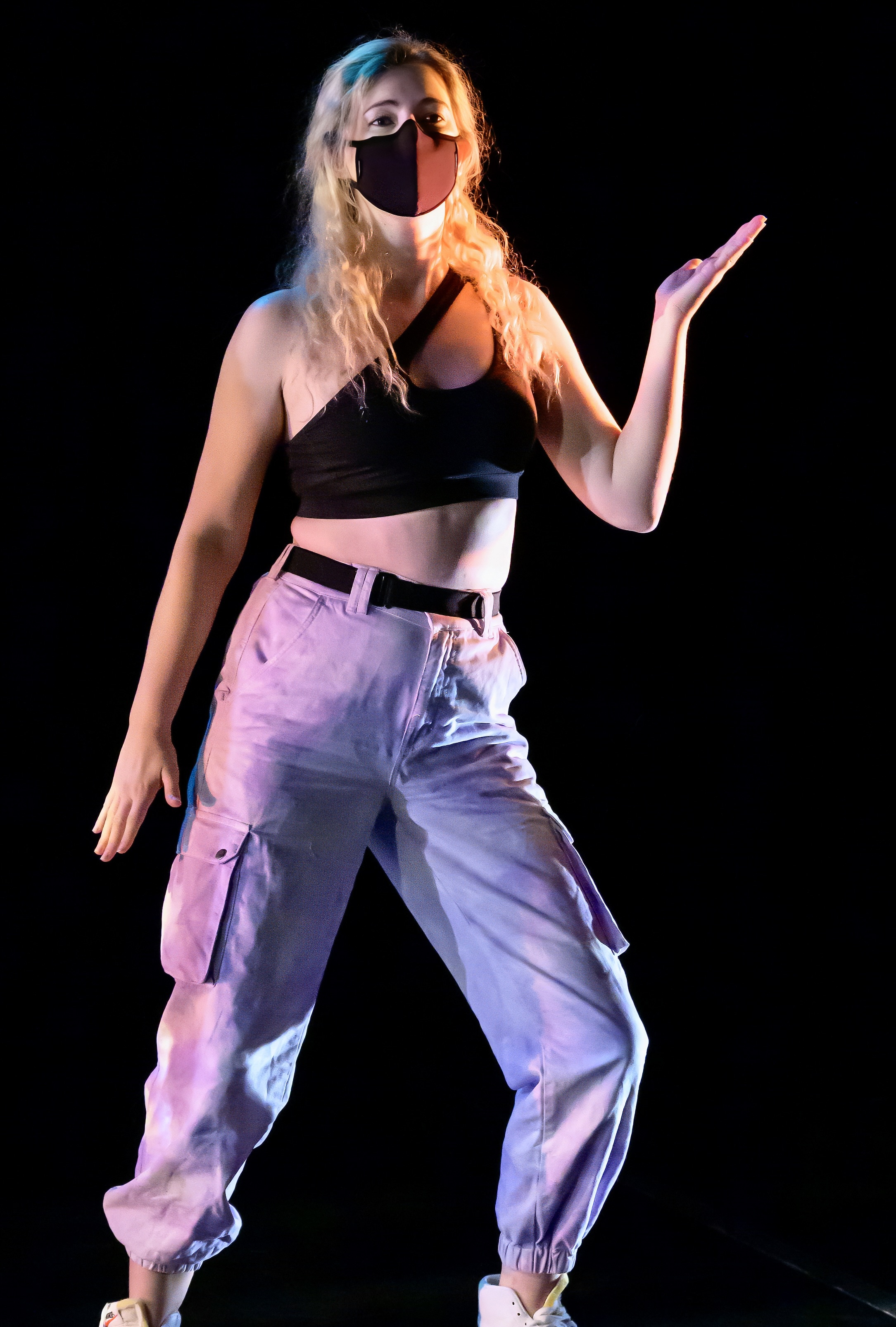 a woman in a black top and purple pants