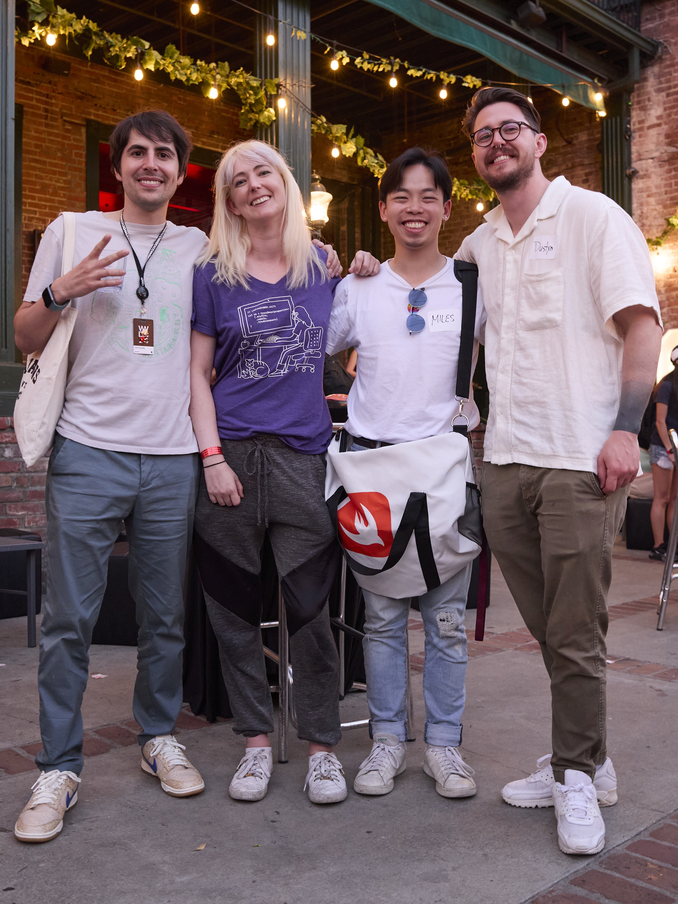 a group of people standing on a sidewalk