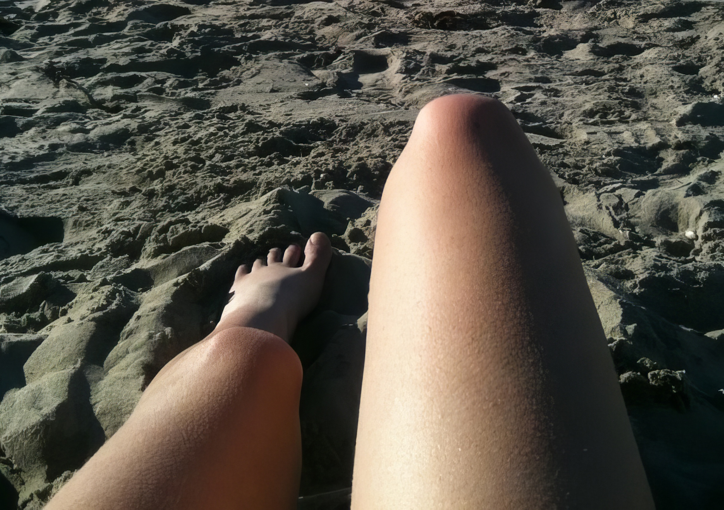 a person's legs on the beach