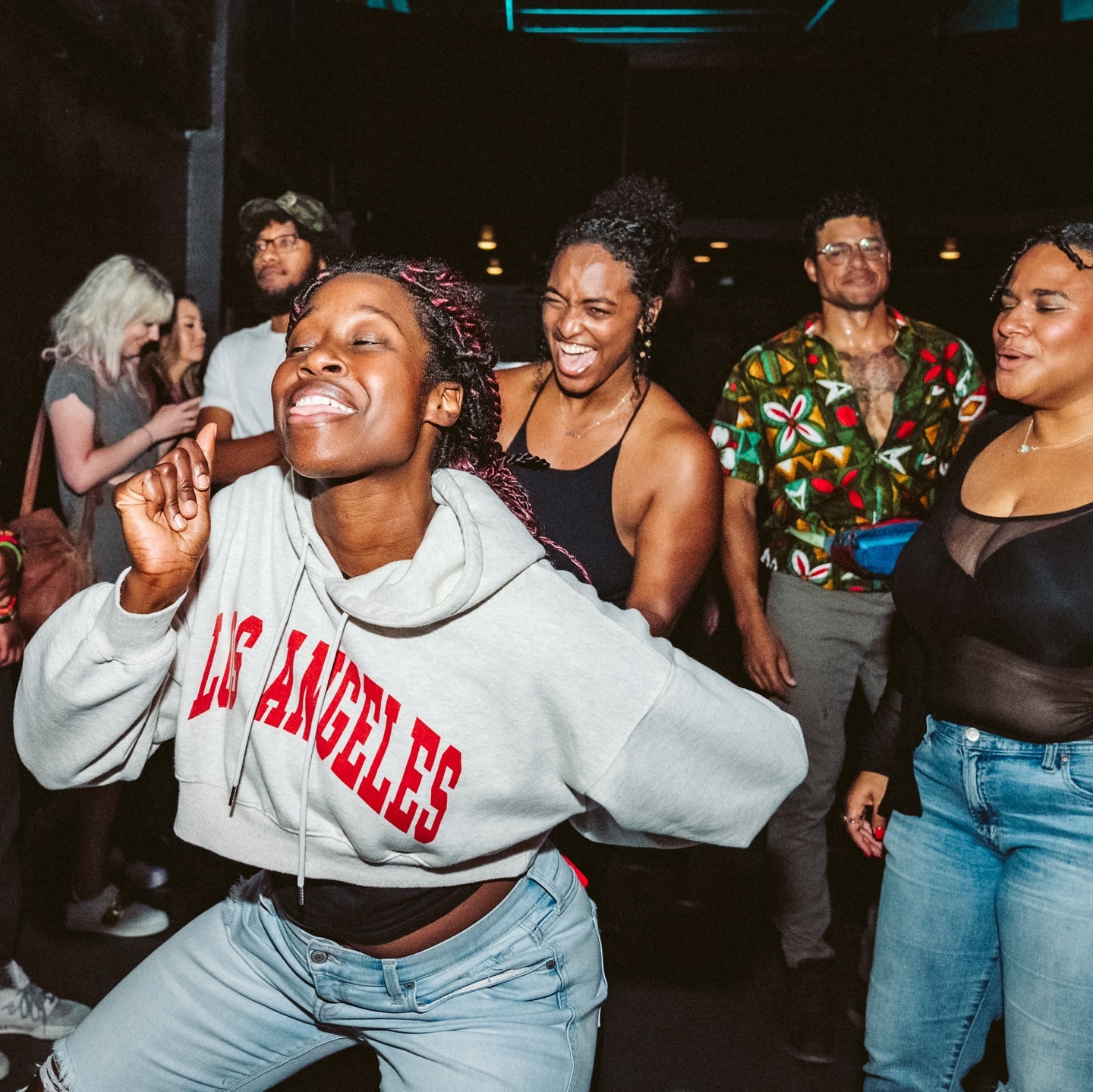 a group of people dancing and having a party